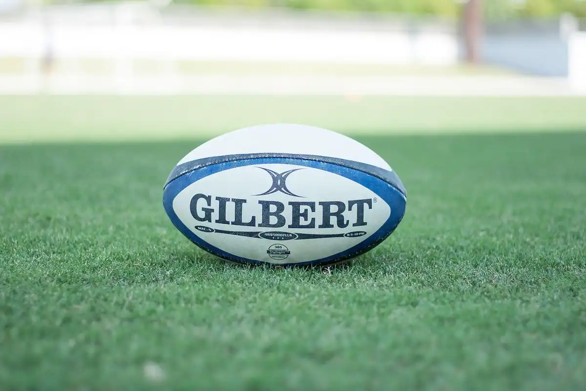 Minge de rugby pe iarba verde a unui teren de joc, pregătită pentru începerea unui meci